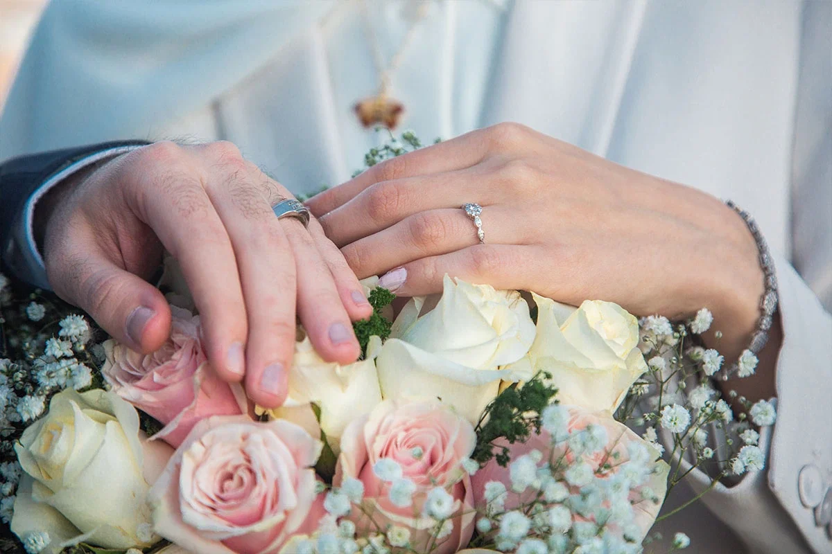 Hands holding an engagement bouquet