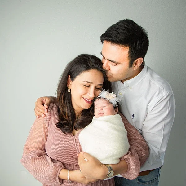 Parents holding their newborn together