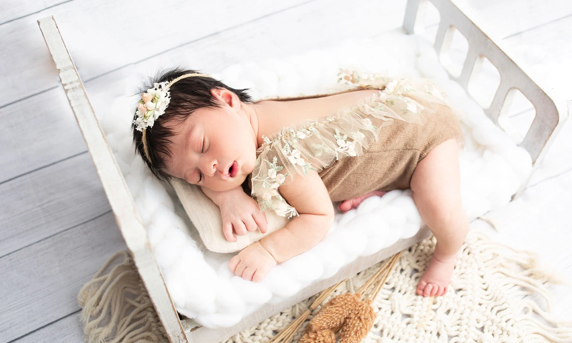 Newborn portrait on a white bed