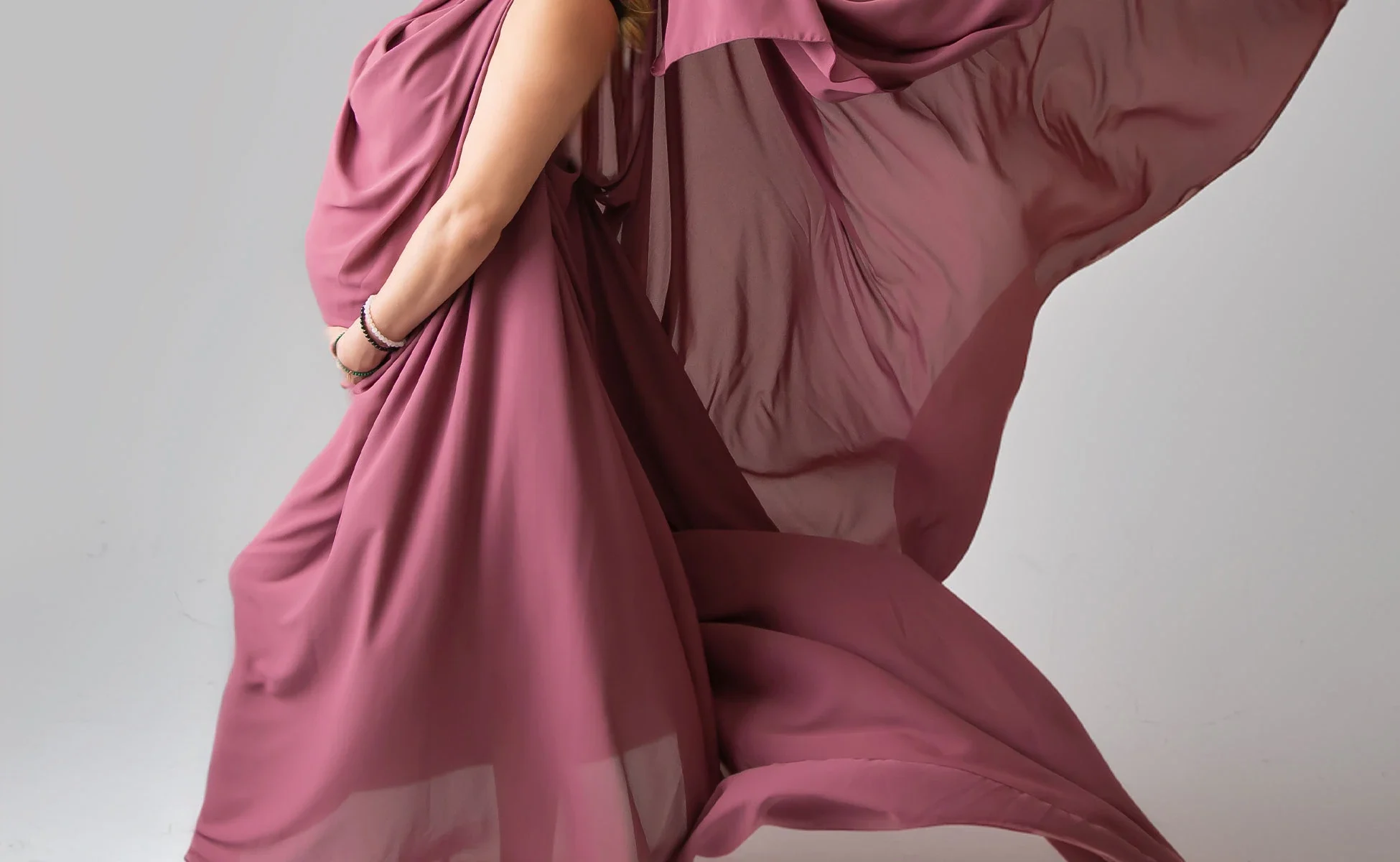 Maternity portrait in a flowing rose dress